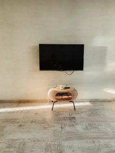 Spacious room featuring a wall-mounted TV in a minimalist style.