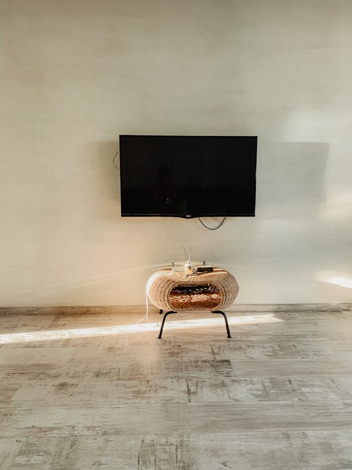 gallery-4 Spacious room featuring a wall-mounted TV in a minimalist style.