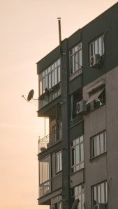 Urban apartment building highlighted against a soft sunset backdrop.